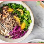 A picture of 15-Minute Meal Prep Sesame Noodle Bowls in a white deep plate and a silver spoon inside