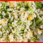 30-Minute Healthy Broccoli Cheese Rice in a plate with a silver spoon in it.