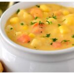 A picture of 5-Ingredient Cheesy Cauliflower Soup in a white plate in a white bowl.