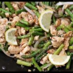 A picture of 5-Ingredient Lemon Chicken Asparagus in a black pan.