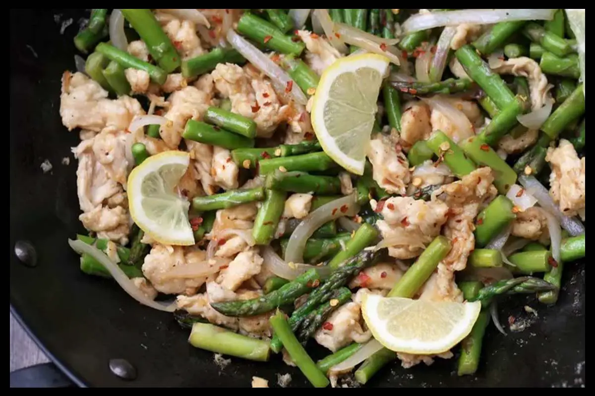 A picture of 5-Ingredient Lemon Chicken Asparagus in a black pan.