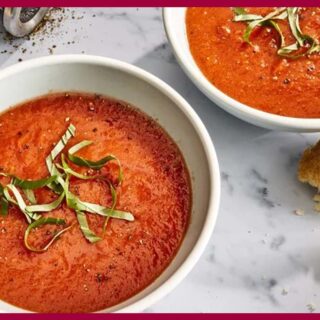 2 plates of 5-Ingredient Tomato Soup on a white table.