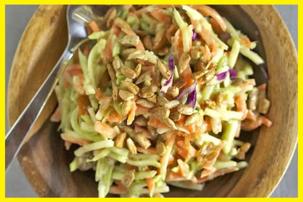 A picture of 5-Minute Green Curry Salad in a wooden bowl with a silver spoon in it.