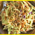 A picture of 5-Minute Green Curry Salad in a wooden bowl with a silver spoon in it.