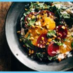 A picture of 7-Layer Beet Salad on a black plate with a spoon in it.