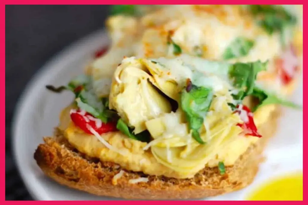 A picture of Artichoke And Red Pepper Melt on a white plate.