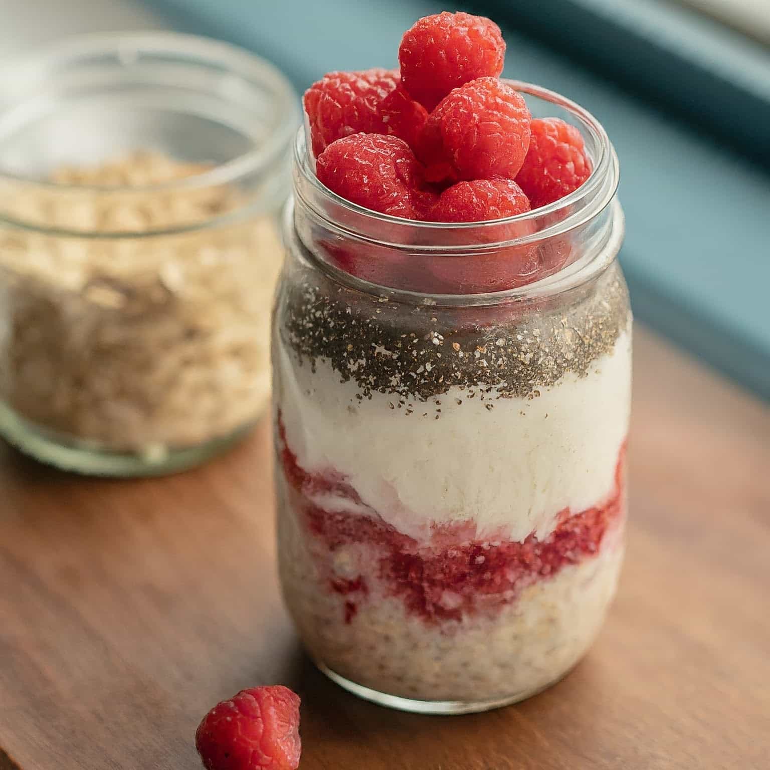 Raspberry Overnight Oats in a mason jar with raspberry on top