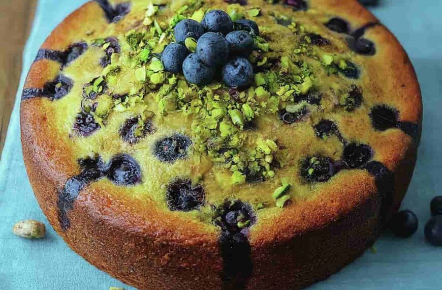 A picture of blueberry orange brunch cake with agave and pistachios