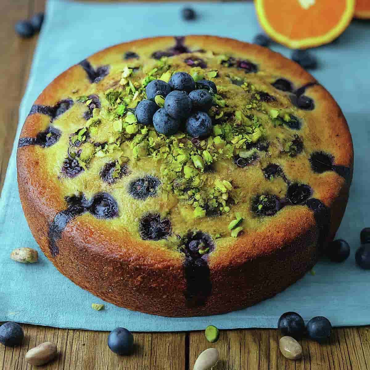 A picture of blueberry orange brunch cake with agave and pistachios